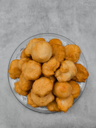 Baursaki, traditional fried dough pastry, on glass plate in prague copy spaceの写真素材