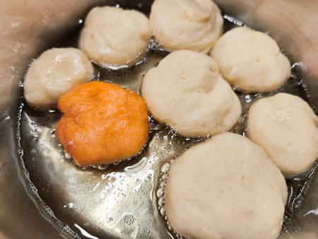 Baursaki doughnuts frying in hot oilの写真素材