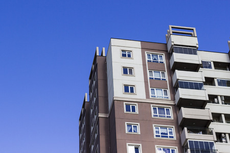 Cropped shot of mass housing concrete building with blue sky