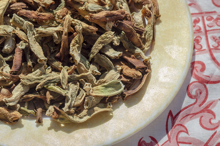 Cropped shoot of traditionally dried under sun string beans on plate with table sheetの写真素材