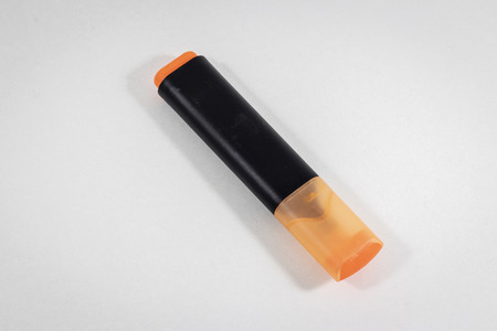 Diagonal shoot of orange colored highlighter pen with white backgroundの写真素材