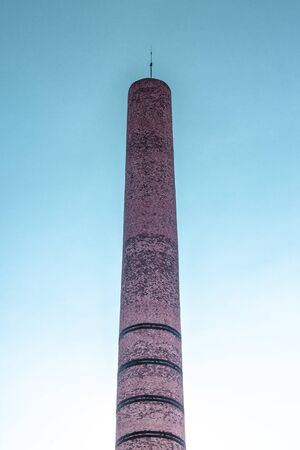 Vertical frame of masonry brick factory chimney with exaggerated color schema