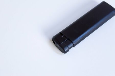 Perspective top shoot of angled full black lighter on white surfaceの写真素材