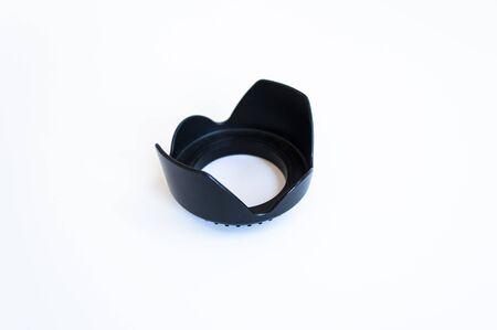 Close-up shoot of blacked colored photo machine lens hood under white surfaceの写真素材