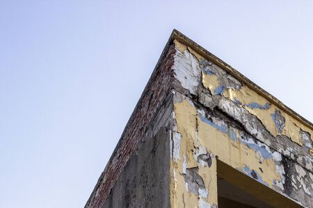 Bottom shoot of old ruined building cormer with brick wall