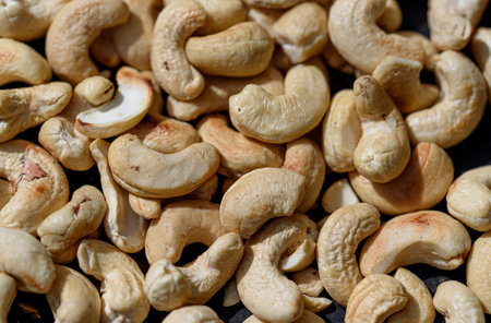 Roasting cashews on an iron plateの写真素材