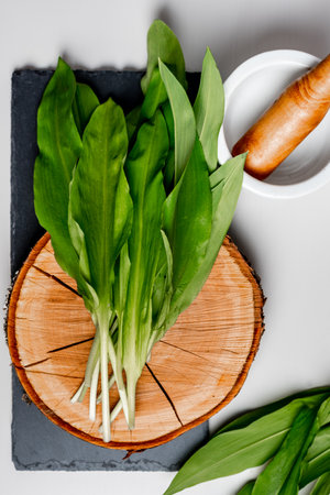 Wild garlic. Wild garlic on a wooden board on a table.の写真素材
