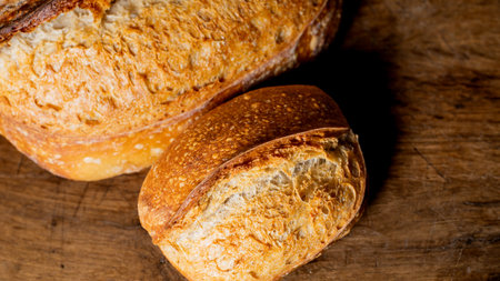 Homemade breads.. Artisanal sourdough whole grain breads on wooden background.
