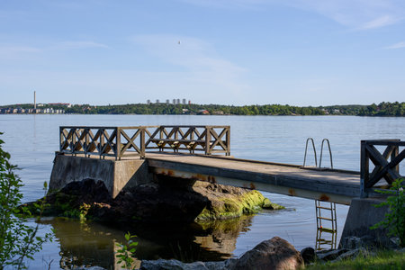 Summer morning at the lake. Wooden dock overlooking a gorgeous lake in the wilderness. Old wooden dock.の写真素材