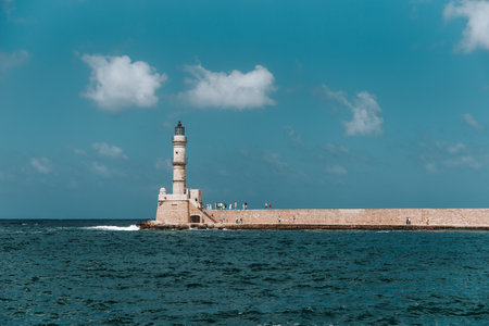 Chania harbor, Crete, Greece, showing Venetian lighthouse and tourists.の写真素材