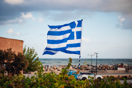 Greek flag on wall near sea on Crete islandの写真素材