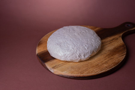 Wooden board with sesame halva on white cake stand.