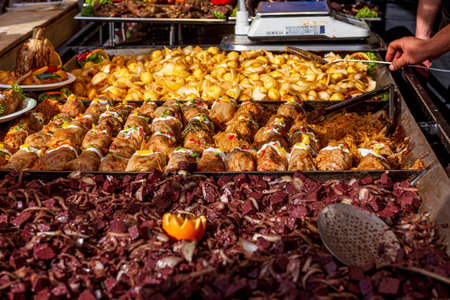 Festival of street food. Various kinds of food served on stainless steel trays. A place to eat for...