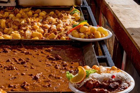 Festival of street food. Various kinds of food served on stainless steel trays. A place to eat for ordinary people. Folk food.の写真素材