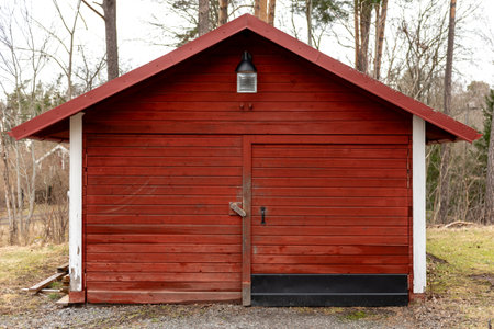 Landscape. Red small traditional wooden building in Sweden.