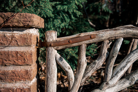 close-up of nice closed wooden gate. rustic door made of tree branches