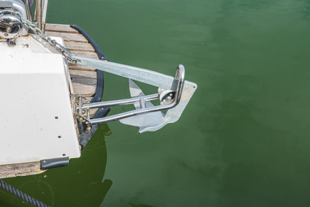 Yacht anchor close-up seen on the front of a vintage boat. A pier for mooring boats and yachts in the port of Sweden.の写真素材