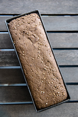 leavened sourdough in the form of homemade rye bread before baking. Loaf of bread with coriander...