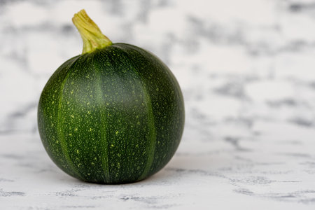 organic round green courgettes zucchini on gray rustic background, copy space.の写真素材