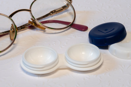 glasses and contact lens holder on white background, top viewの写真素材