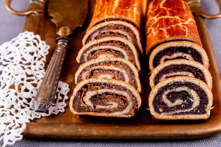 Traditional Hungarian Christmas cookies with poppy seed and walnut on a copper serving tray.の写真素材