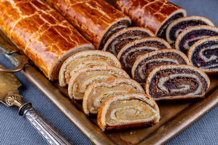 Traditional Hungarian Christmas cookies with poppy seed, walnut and almond on a vintage copper serving trayの写真素材