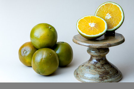 Navel Chocolate Oranges on the cake stand. White background. Chocolate orange, also a type of Navel orange, a mutation that was first discovered in 2006 in Valencia, Spain.の写真素材