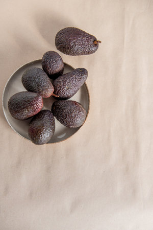 The ripe Hass avocado on craft paper, close-up, top view.