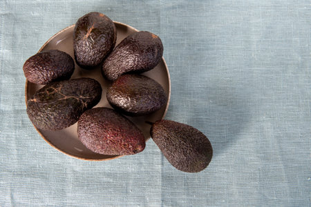 The Hass avocado on textile background. top view. flatlay