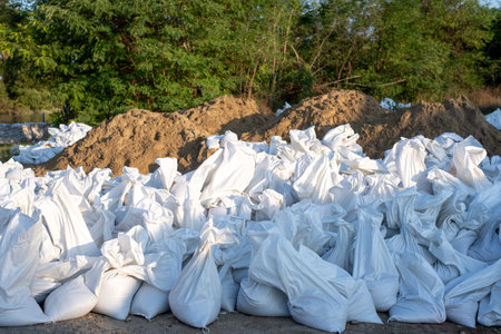 A sack is filled with sand to be used as a wall to prevent flooding in urban areas.の写真素材