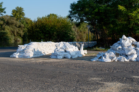 A sack is filled with sand to be used as a wall to prevent flooding in urban areas.の写真素材