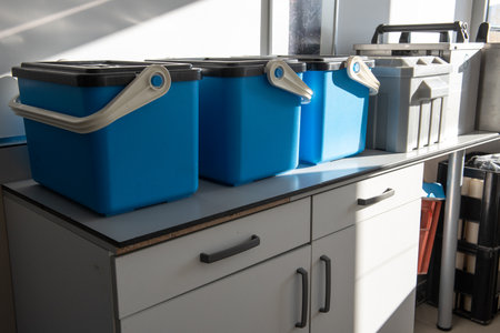 Accessories and containers placed on a lab counter, used for collecting and storing water samples...