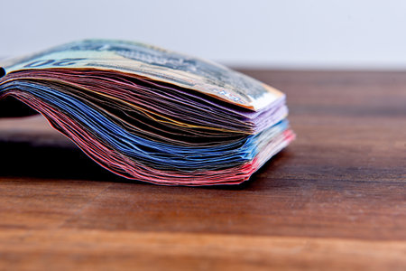 Hungarian HUF banknotes, pile of money on a brown tableの写真素材