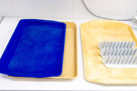 plastic tube racks on a yellow plastic tray. laboratory equipment.