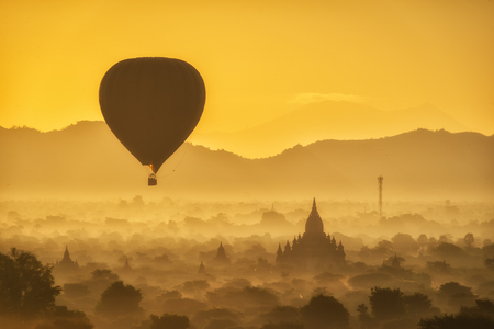 Balloons over Buddhist temples at sunrise in Bagan, Myanmar.の写真素材