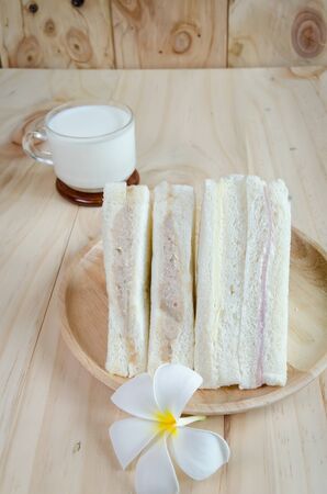glass of milk and sandwich on wood backgroundの写真素材