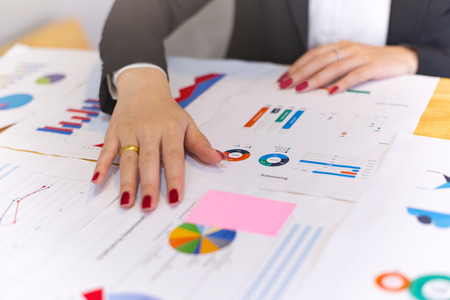 Modern business woman design Ideas and analyzing income charts and graphs in the office .workplace strategy and entrepreneurship concept.の写真素材