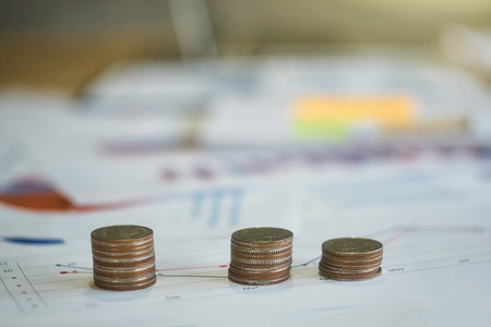 Saving stack coins money concept. analyzing income charts and graphs money coin stack growing business.の写真素材
