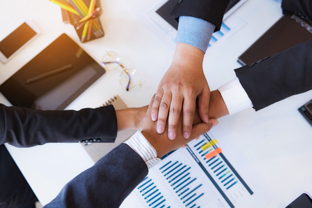 Business people shaking hands after finishing up a meeting good teamwork in office.Teamwork...