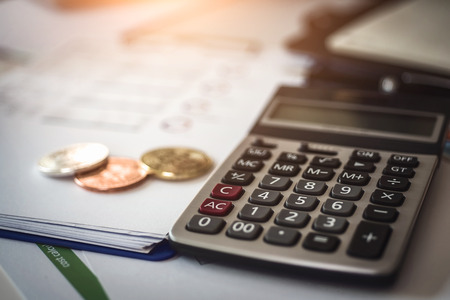 Accounting cryptocurrencies investors of bitcoins with documents and calculator in background.の写真素材