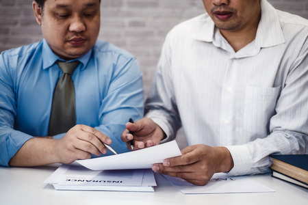 Two male lawyer discussing with contract papers and wooden gavel on tabel in courtroom. justice and law ,attorney, court judge, conceptの写真素材