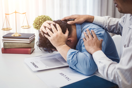 Business man sit strain serious for problem of contract  insurance with lawyers consolation to solution the issue in office. justice and law ,attorney, court judge, concept.の写真素材