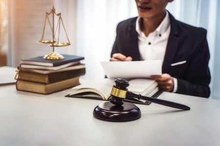 Focus of wooden gavel on table with male lawyer on background.  justice and law ,attorney, court judge, concept.の写真素材