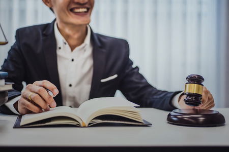 Focus of wooden gavel on table with male lawyer on background.  justice and law ,attorney, court judge, concept.の写真素材