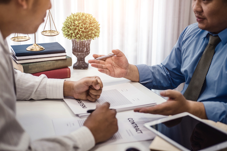 Businessman explaining terms and conditions with contract  insurance agreement before he sign the document.の写真素材