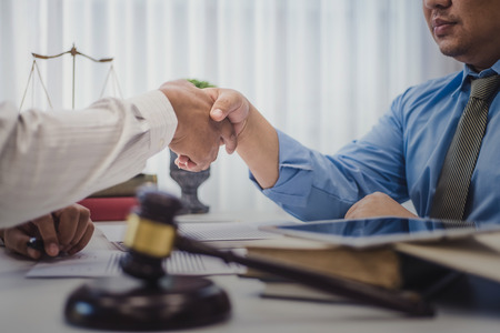 Businessman shaking hands with lawyers after discussing a contract agreement in office. justice and law ,attorney, court judge, concept.の写真素材