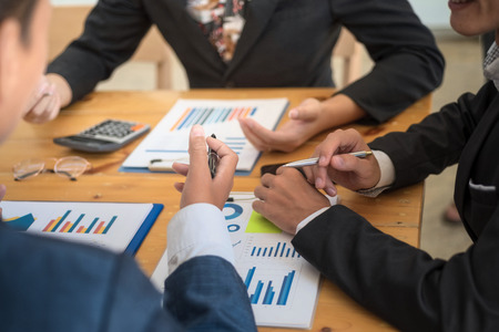 Group of business people discussing with analyzing data financial report at the office desk on montly meeting. Accounting concept.の写真素材