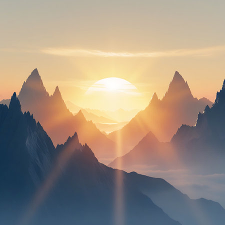A dramatic sunrise occurs between sharply defined mountain peaks. The sun is a bright orb, its rays fanning out and illuminating the misty valleys below. The foreground mountains are dark silhouettes, contrasting with the warm, glowing sky. A hint of water is visible in the far distance, adding to the serene landscape.の素材