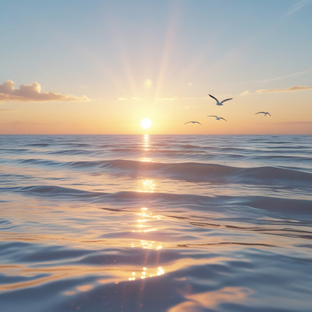 A flock of seagulls glides through the air over the gently rippling ocean water as the sun rises. The bright sun creates a prominent sunburst, with its rays reflecting on the water's surface. The sky is a soft gradient of blue and orange, with a few scattered clouds, creating a peaceful and expansive seascape.の素材