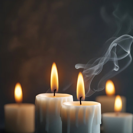 Several white pillar candles are lit, with their flames casting a warm, orange glow. Wisps of white smoke curl upwards from the wicks, creating an ethereal and atmospheric effect against a dark, moody background. The wax on the candles shows signs of melting and dripping, adding texture and depth to the scene.の素材